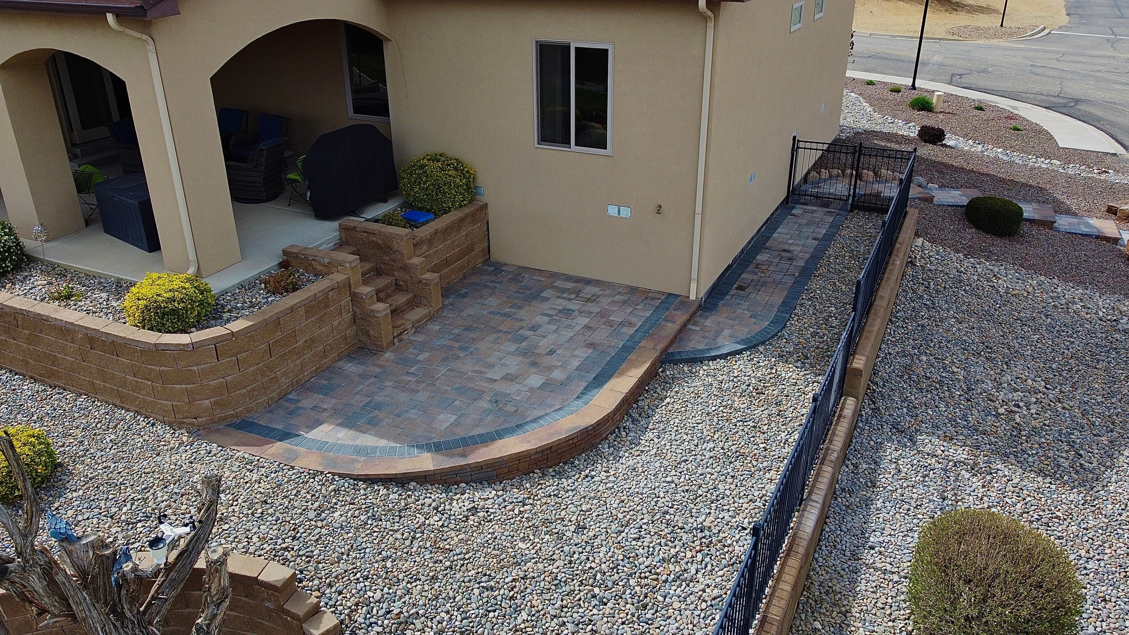 Raised paver patio with walkway and stairs installed in Farmington NM by High Desert NativeScapes