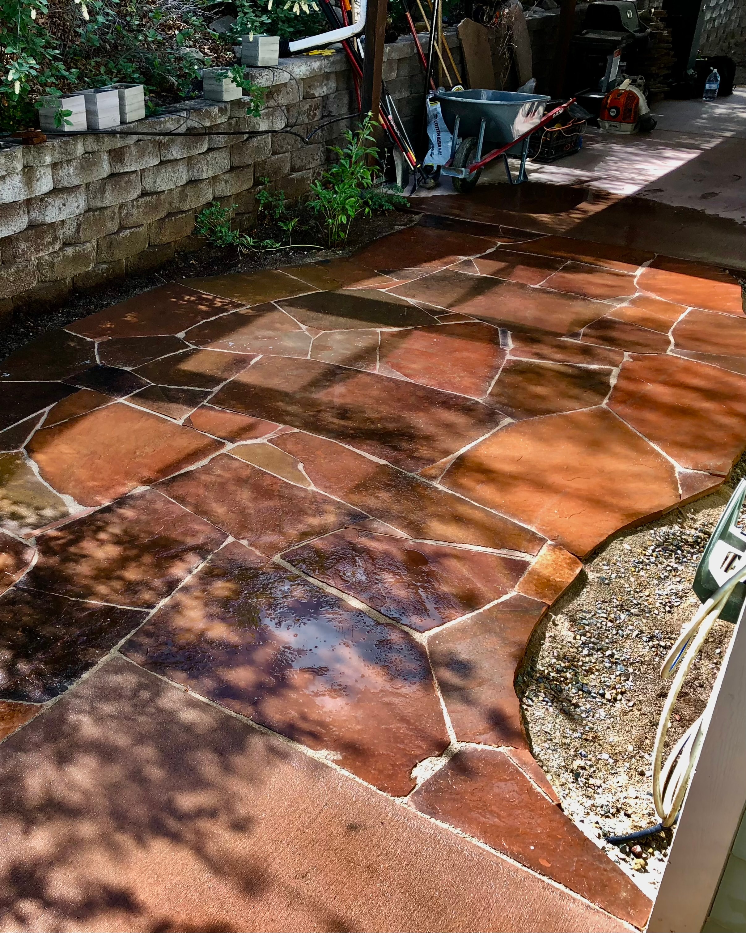 Custom flagstone patio installation in Farmington NM by High Desert NativeScapes — natural stone hardscape
