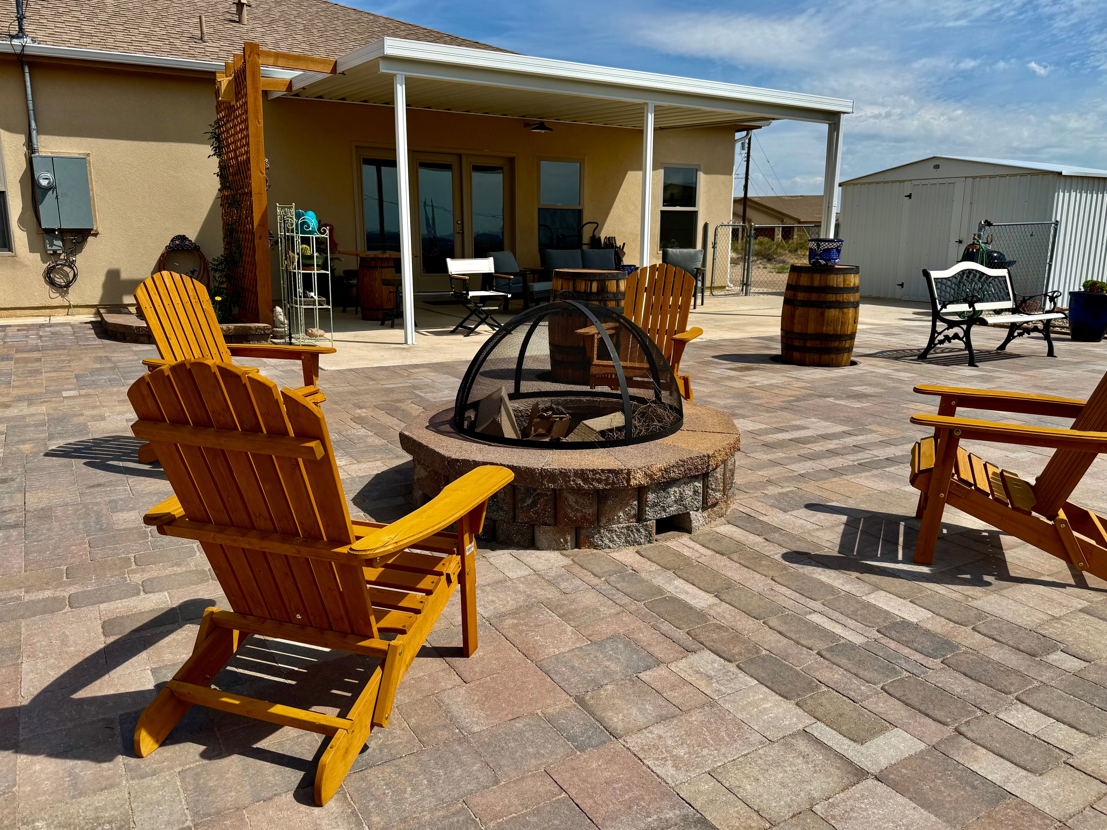 Backyard fire pit patio with built-in seating installed in Farmington NM by High Desert NativeScapes